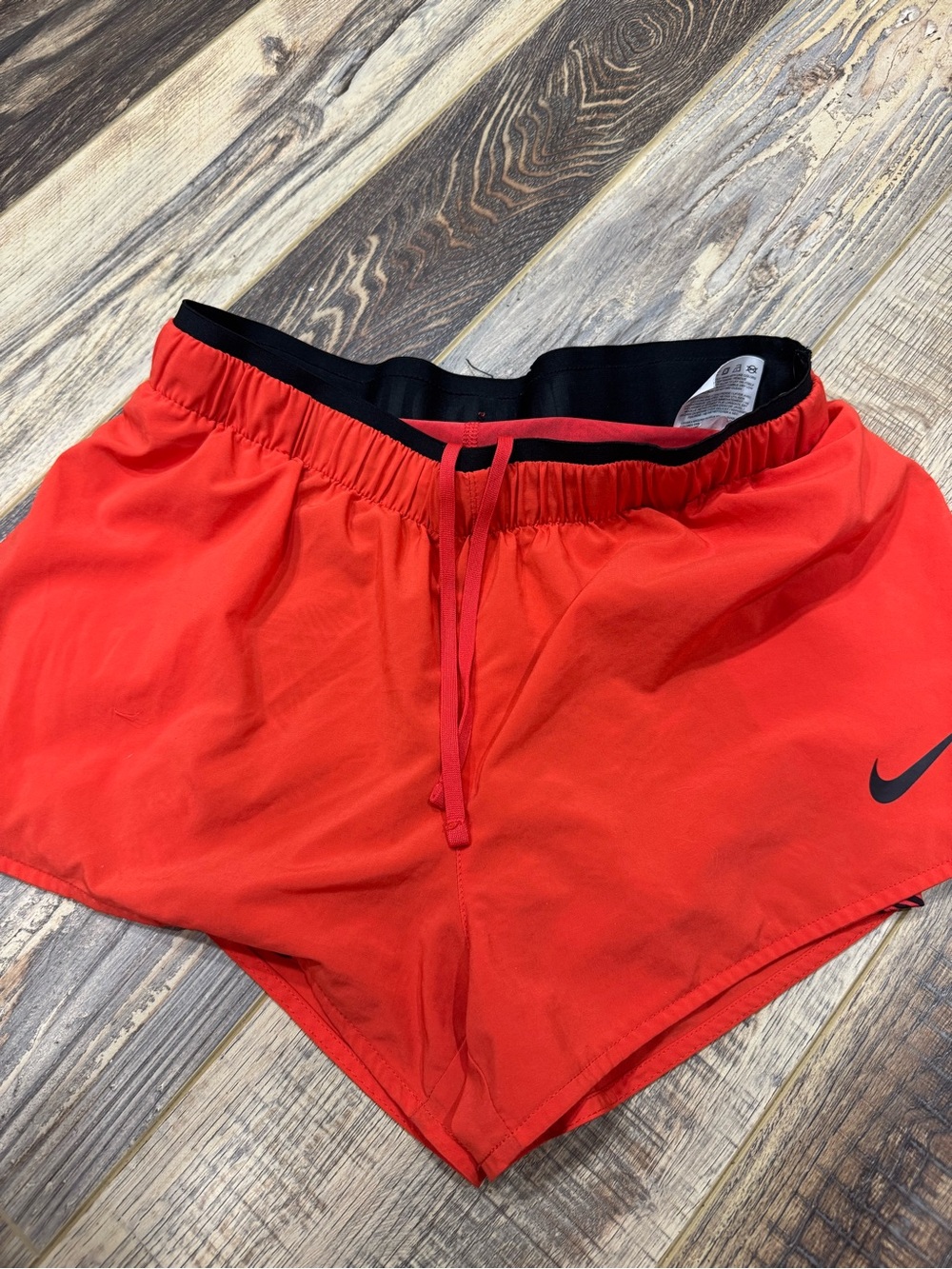 Nike Women’s Red/Coral Athletic Shorts with Black Waistband and Swoosh